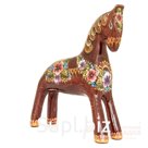 A bay horse with a flower harness