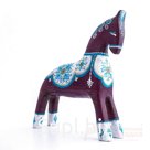 A dark cherry-colored horse with an ornament